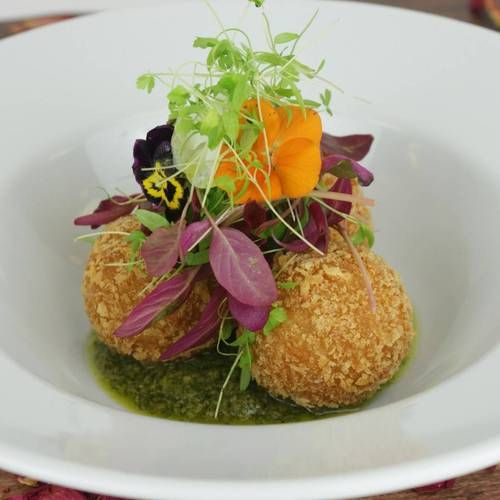 Warm arancini balls with homemade salsa Verde and micro cress salad